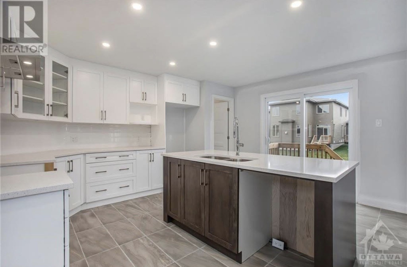 Kitchen island and cabinetry inspiration at 572-580 Chambord Street