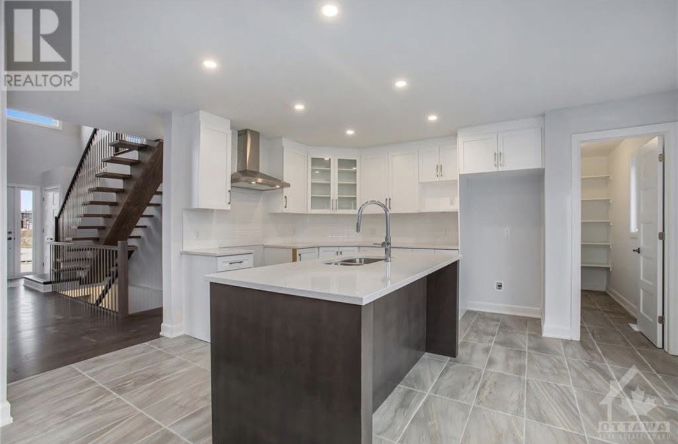 Open-concept kitchen inspiration at 572-580 Chambord Street